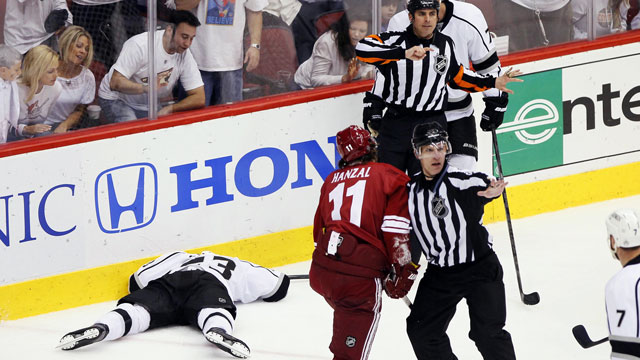 Martin Hanzal of the Phoenix Coyotes crushes L.A. Kings’ captain Dustin Brown from behind into the boards in Game 2 of the Western Conference final. Hanzal gets one game and Brown goes on to win the cup. (AP/Matt York)