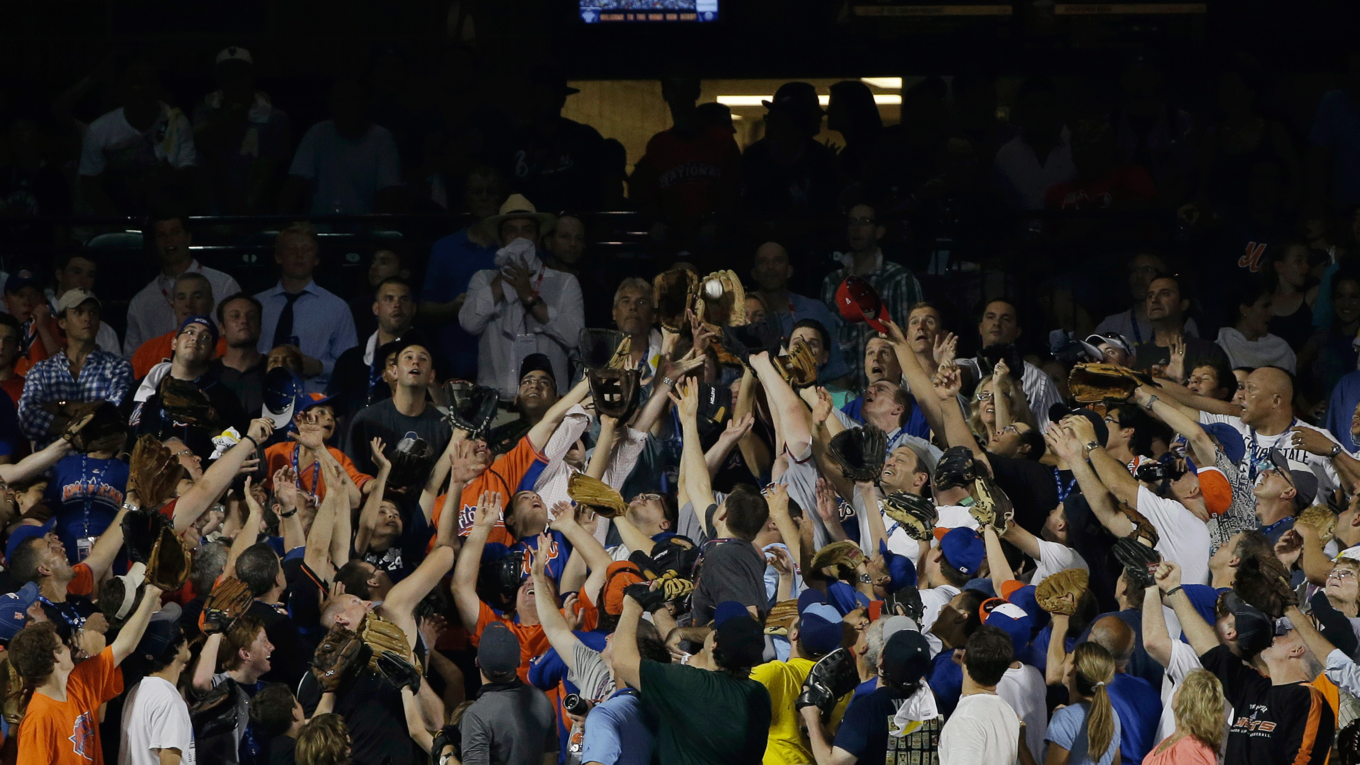 A fan catches a dinger among a sea of competing gloves. (AP/Matt Slocum)