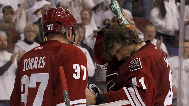 Chicago Blackhawks’ forward Andrew Shaw clips Phoenix Coyotes goaltender Mike Smith in the head in Game 2 of their first-round playoff series. Smith is fine but Shaw gets three games anyway. (AP/Ross D. Franklin)