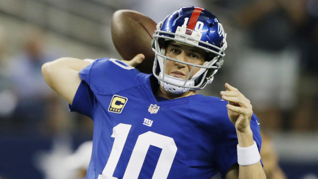 Eli Manning was only slightly outdone by his brother (minus the three interceptions and the loss), throwing for 450 yards and four touchdowns (AP/Tony Gutierrez) 