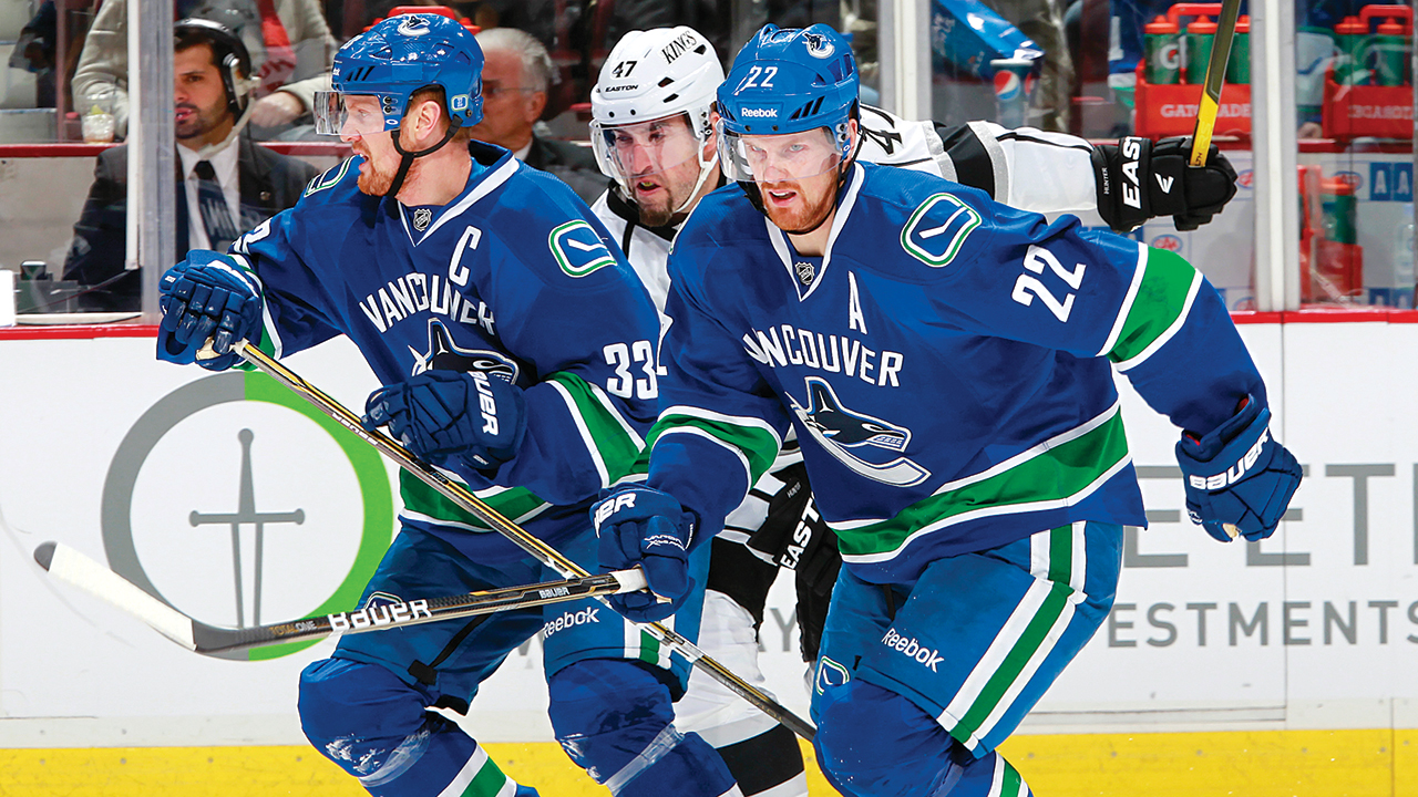 Henrik-Sedin-and-Daniel-Sedin-of-the-Vancouver-Canucks-pursue-the-puck