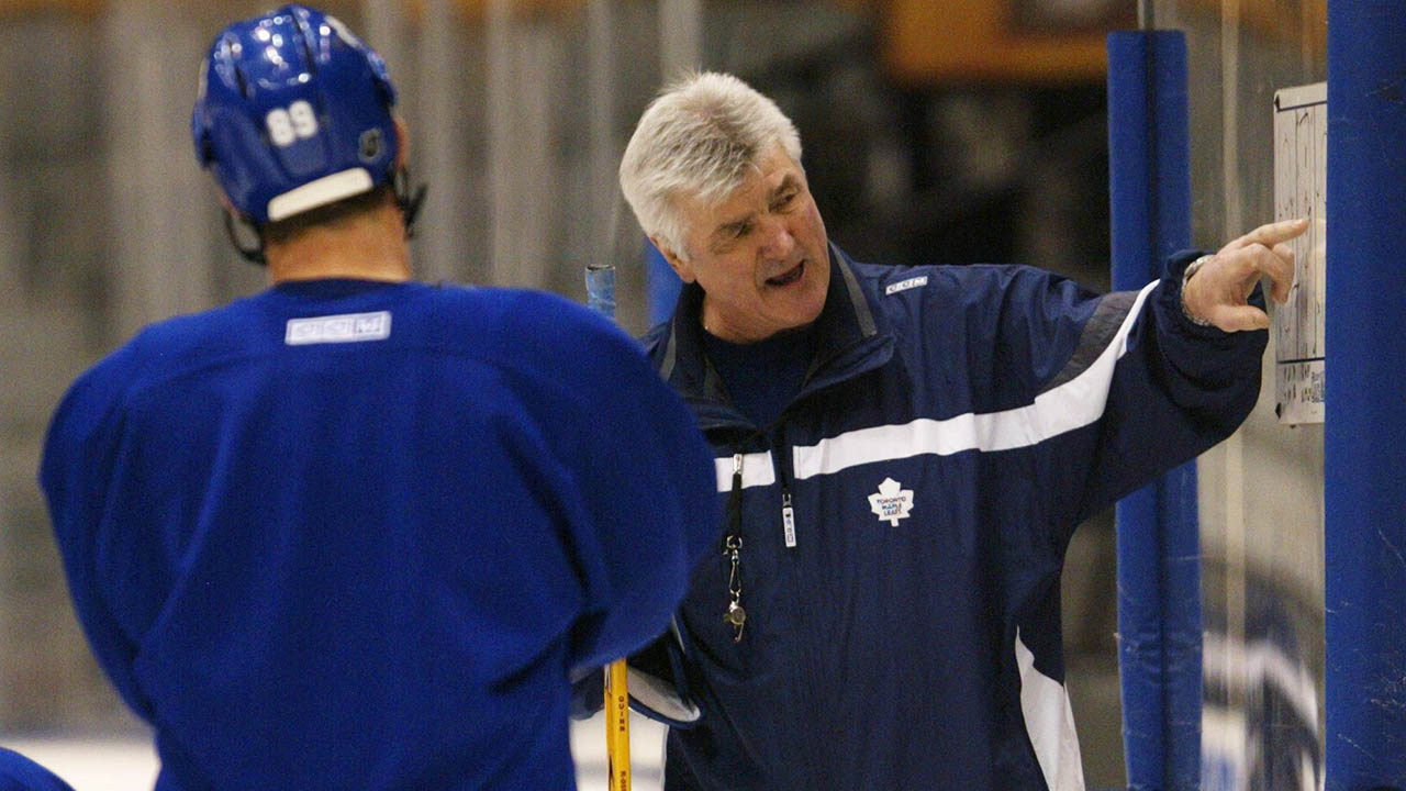 Pat-Quinn-gives-instructions-to-Maple-Leafs-players-during-practice-in-Toronto-on-April-15,-2004