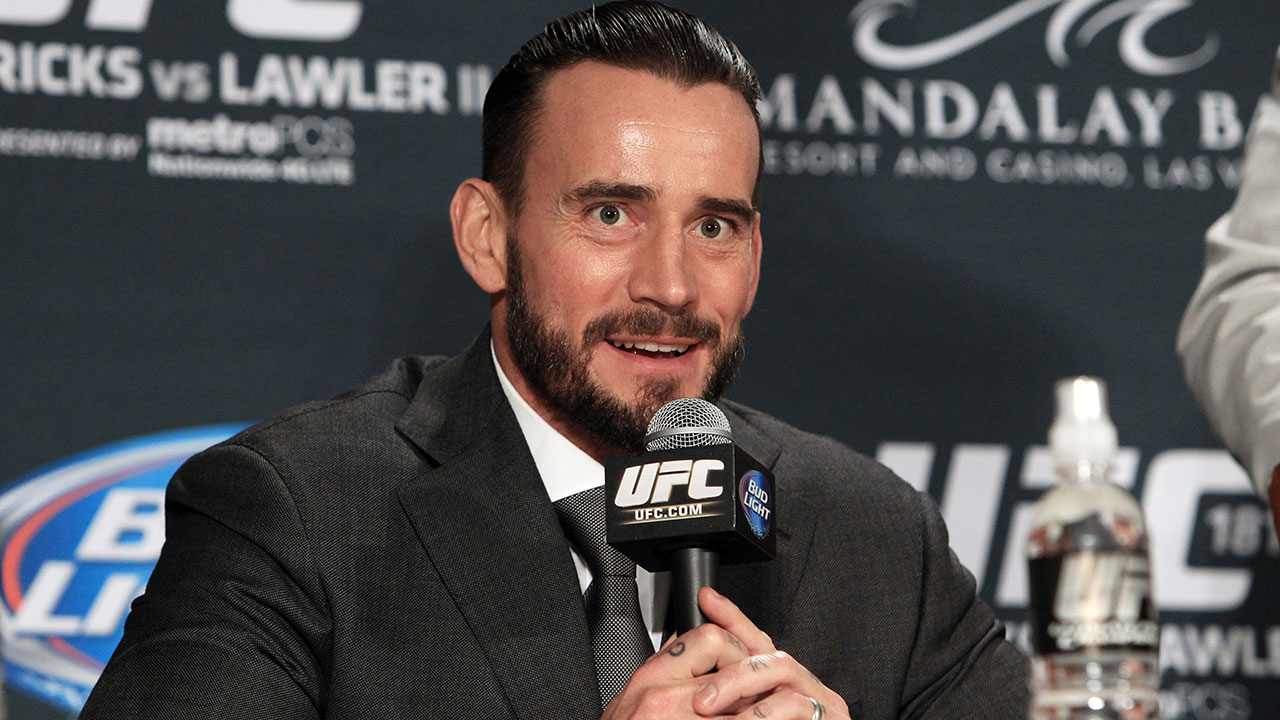 Former-WWE-professional-wrestler-CM-Punk-speaks-at-a-news-conference-after-signing-a-contract-with-the-UFC.