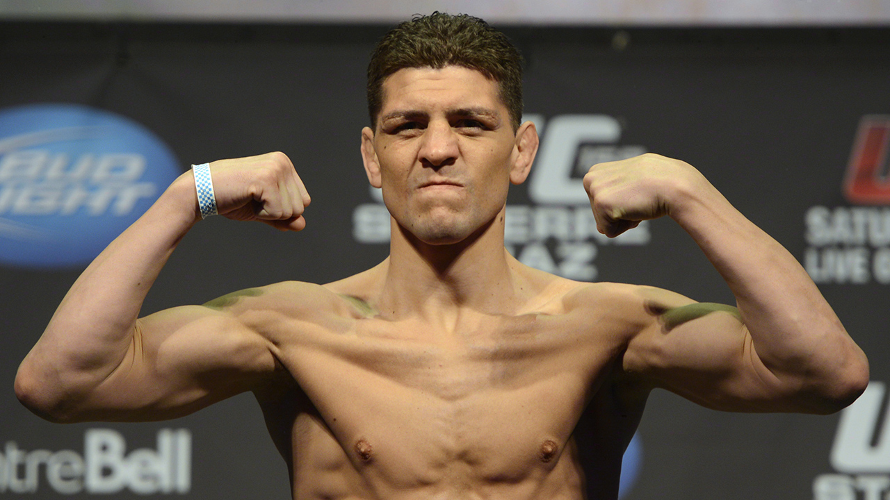 UFC-fighter-Nick-Diaz-flexes-during-the-weight-in-for-UFC-158-in-Montreal.