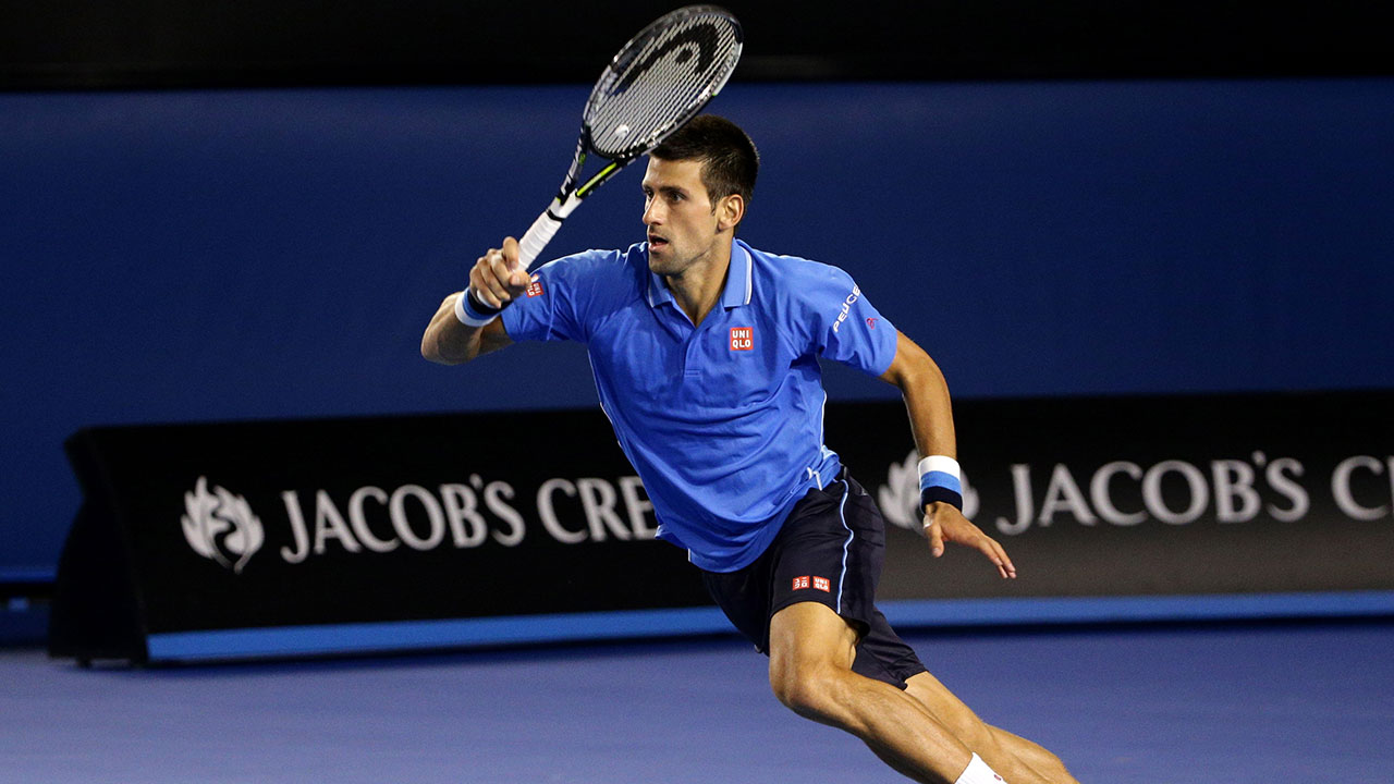 Novak Djokovic plays a shot to Stan Wawrinka during their semifinal at the Australian Open in Melbourne. (Rob Griffith/AP)