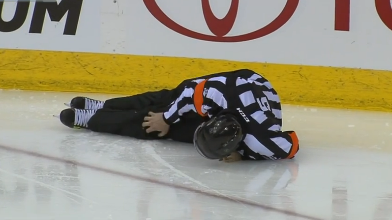 NHL official Rooney hit by puck, leaves game