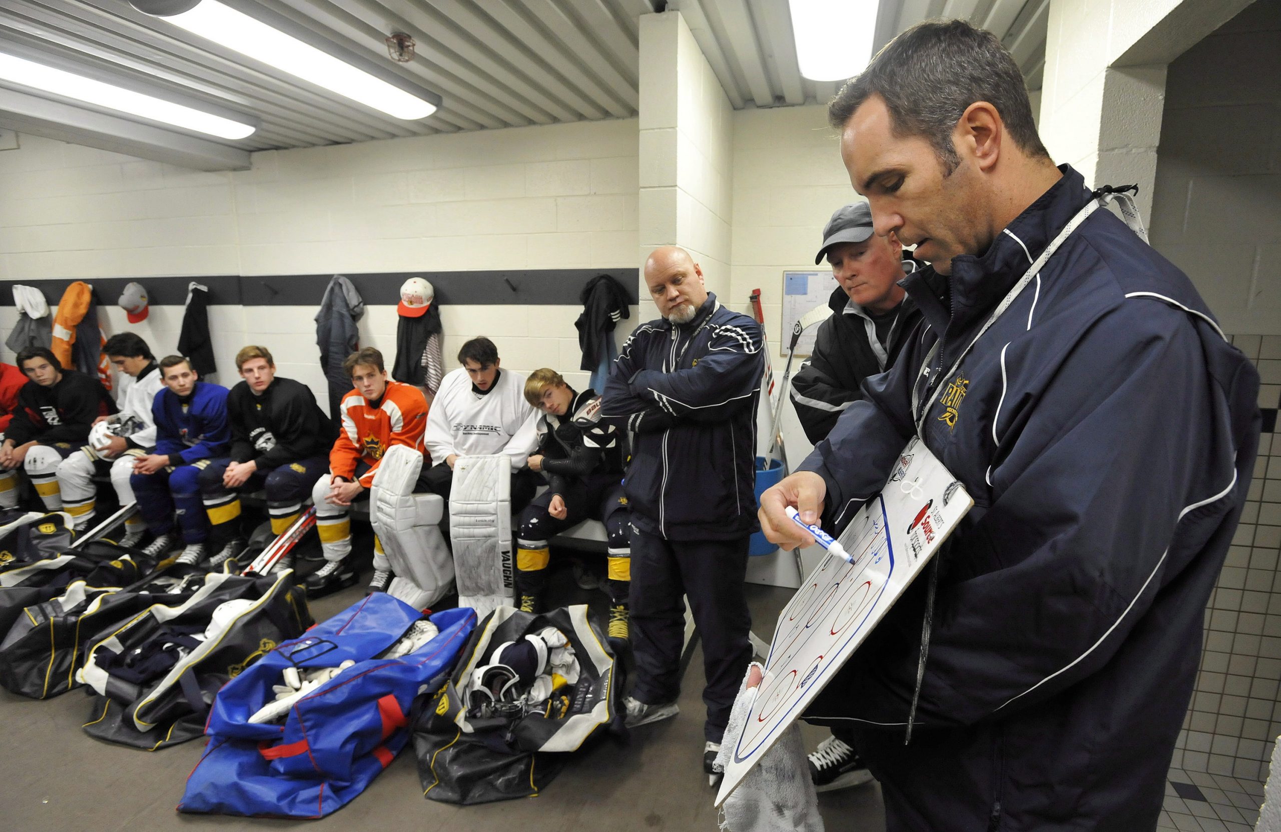 Former-NHL-player-Chris-Joseph-(right),-co-coach-of-the-St.-Albert-Midget-AA-Blues,-outlines-a-drill-prior-to-practice-in-St.-Albert,-Alta.,-Tuesday,-Sept.-23,-2014.-(Dan-Riedlhuber/CP)