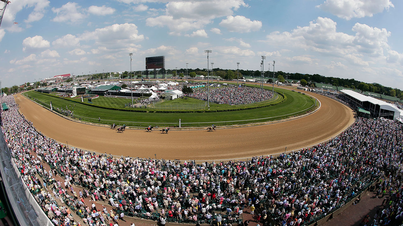 Fans watch a race before the 141st running of the Kentucky Derby horse race at Churchill Downs. (Charlie Riedel/AP)