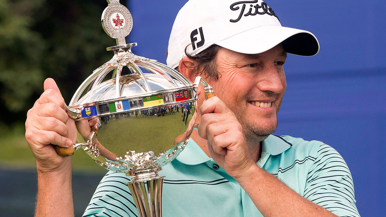 Tim-Clark,-from-South-Africa,-holds-his-Canadian-Open-Championship-trophy-after-final-round-play-at-the-Canadian-Open-golf-championship-in-2014,-(CP/Ryan-Remiorz)