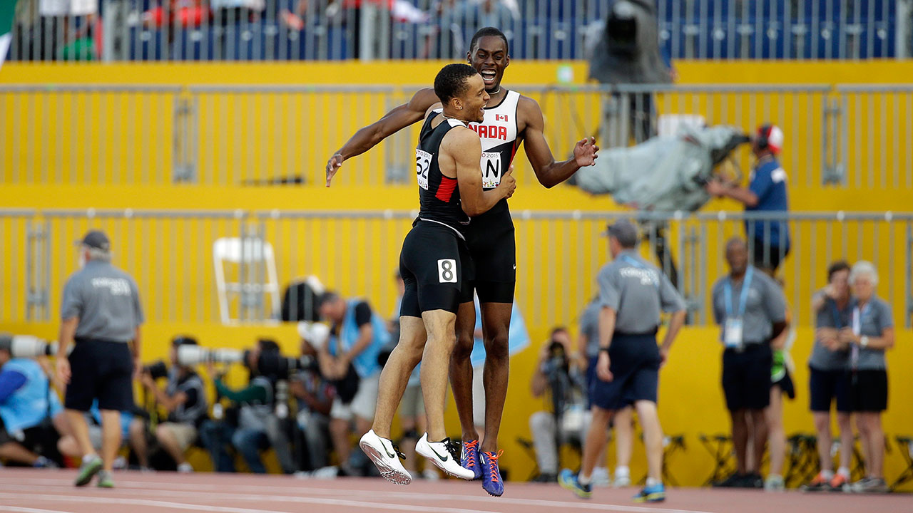 Canada's Andre De Grasse, left, and relay teammate Brendon Rodney. (Mark Humphrey/AP)