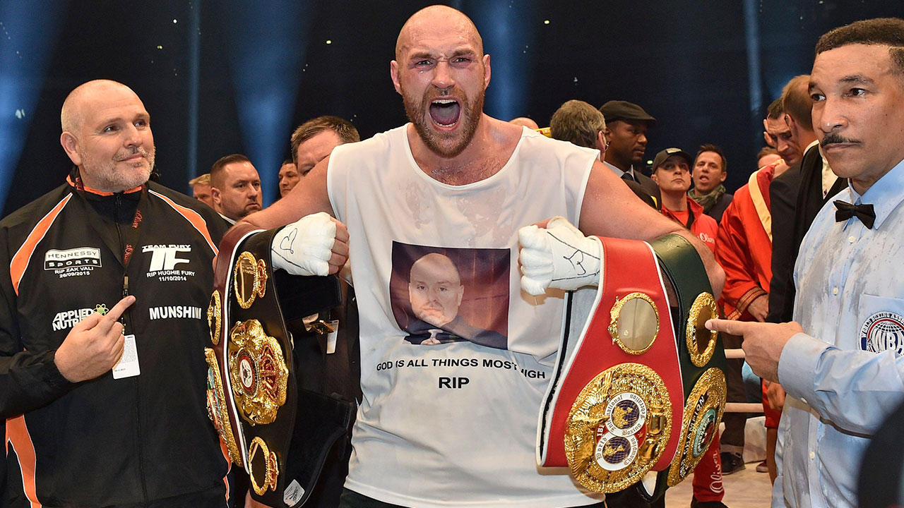Tyson-Fury-seen-here-celebrating-with-the-WBA,-IBF,-WBO-and-IBO-belts-after-winning-a-world-heavyweight-title-fight-against-Wladimir-Klitschko-in-2015.