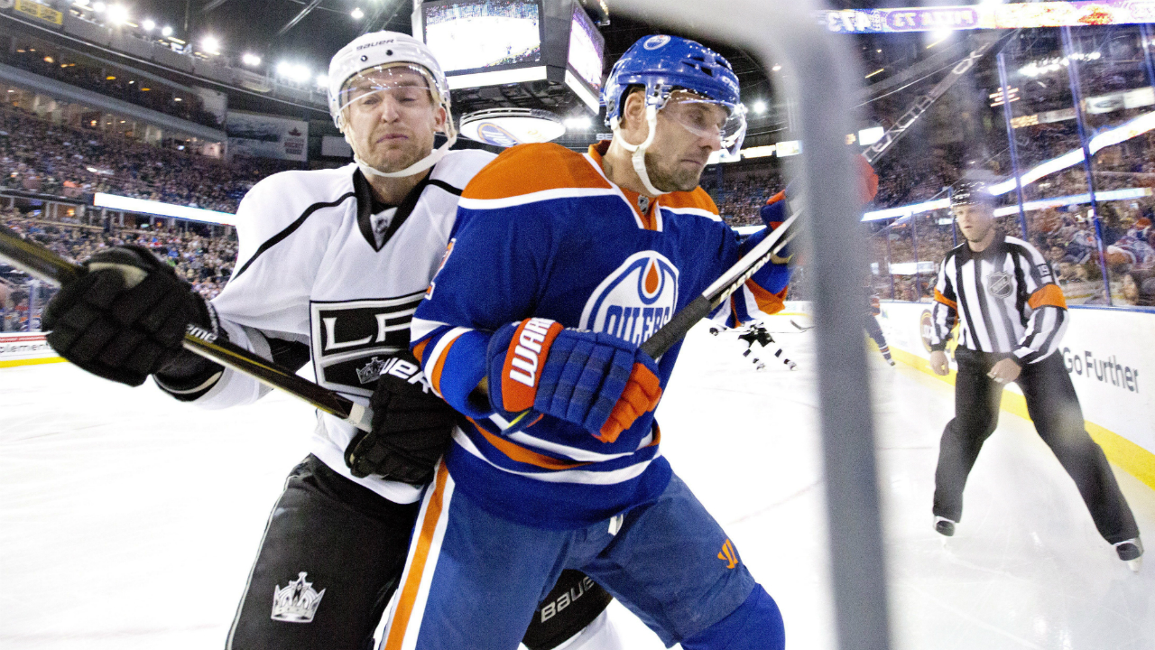 Los-Angeles-Kings'-Trevor-Lewis-(22)-checks-Edmonton-Oilers'-Andrej-Sekera-(2).-(Jason-Franson/CP)