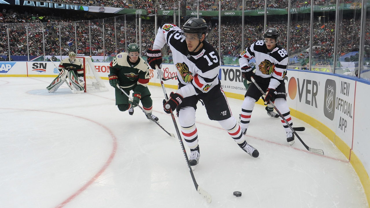 Chicago-Blackhawks-center-Artem-Anisimov,-center-looks-to-pass-the-puck-while-pursued-by-Minnesota-Wild-defensemen-Ryan-Suter,-second-left,-as-Wild-goalie-Devan-Dubnyk,-left,-and-Blackhawks,-right-wing-Patrick-Kane,-right,-look-on-during-the-first-period-of-an-NHL-Stadium-Series-hockey-game-at-TCF-Bank-Stadium,-Sunday,-Feb.-21,-2016,-in-Minneapolis.-(AP-Photo/Craig-Lassig)