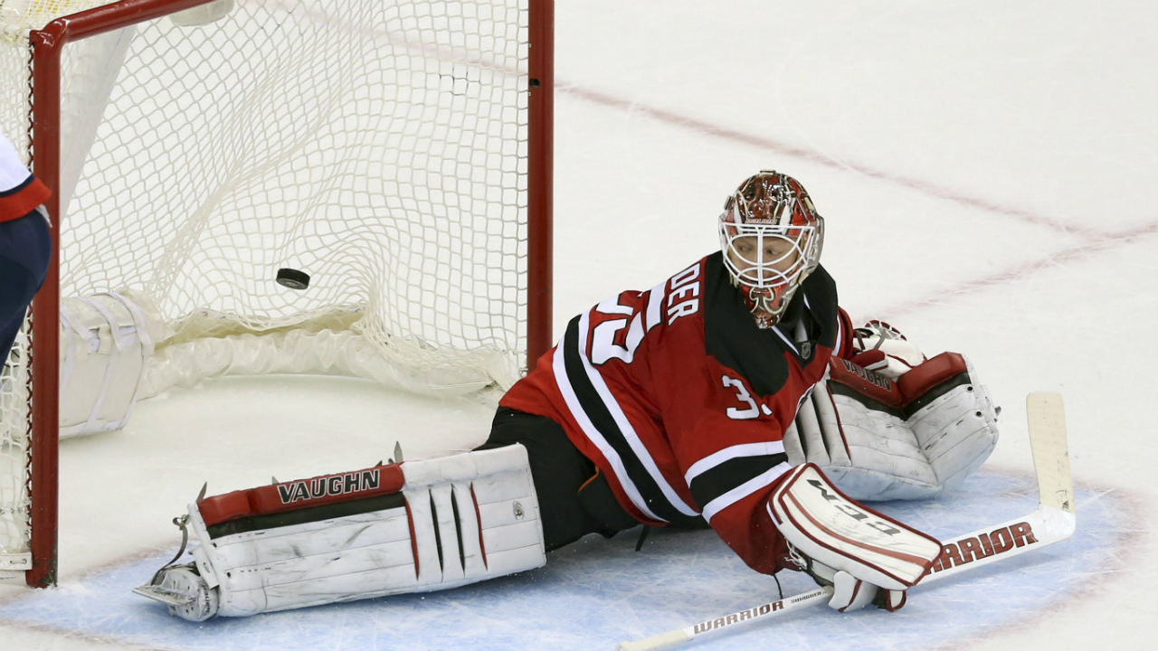 New-Jersey-Devils-goalie-Cory-Schneider-(35)-watches-as-the-shot-by-Washington-Capitals-left-wing-Alex-Ovechkin-(8),-from-Russia,-goes-in-the-net-to-score-a-winning-goal-during-a-a-shootout-in-an-NHL-hockey-game-Saturday,-Feb.-6,-2016,-in-Newark,-N.J.-The-Capitals-won-3-2-in-a-shootout.-(AP-Photo/Mel-Evans)