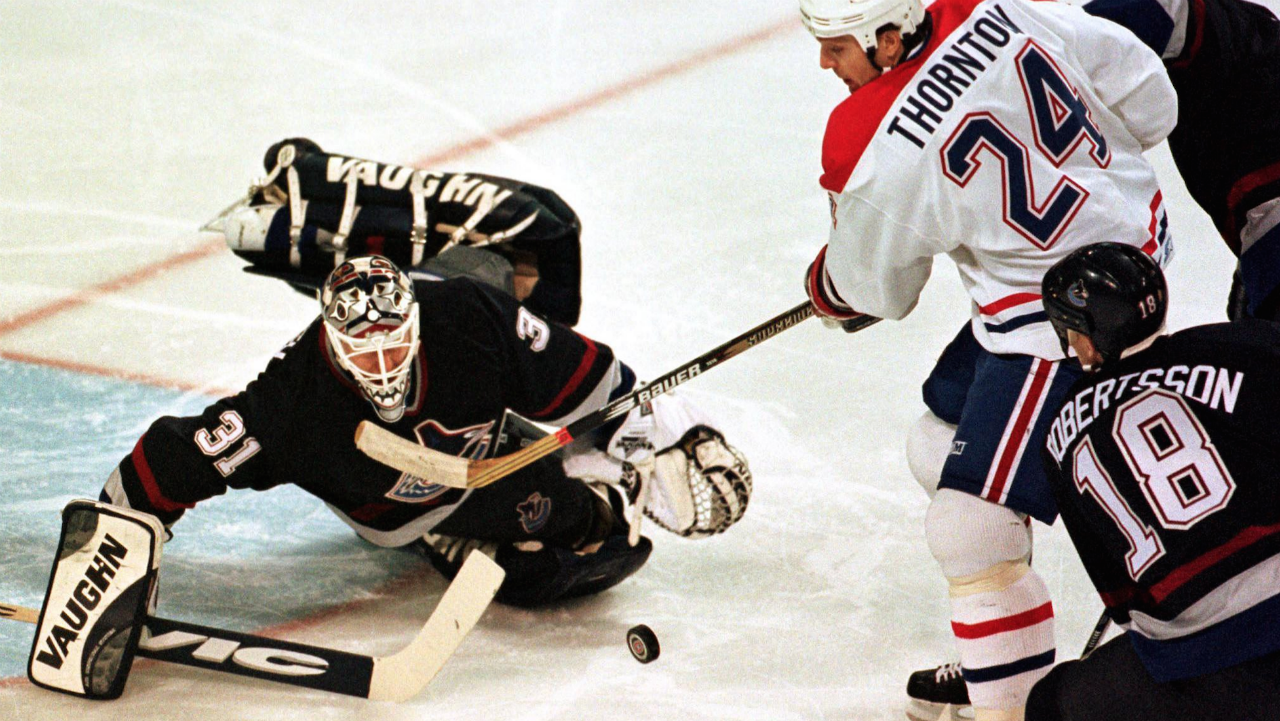 Montreal-Canadiens-Scott-Thornton-is-stopped-by-Vancouver-Canucks-goaltender-Corey-Hirsch-as-defencemen-Bert-Robertsson-and-Murray-Baron-move-in-during-first-period-NHL-action.(Ryan-Remiorz/CP)