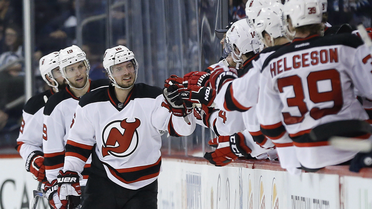 New-Jersey-Devils'-Jacob-Josefson-(16),-Travis-Zajac-(19)-and-David-Schlemko-(8)-and-their-bench-celebrate-Josefson's-goal-against-the-Winnipeg-Jets-during-second-period-NHL-action-in-Winnipeg-on-Saturday,-January-23,-2016.-THE-CANADIAN-PRESS/John-Woods