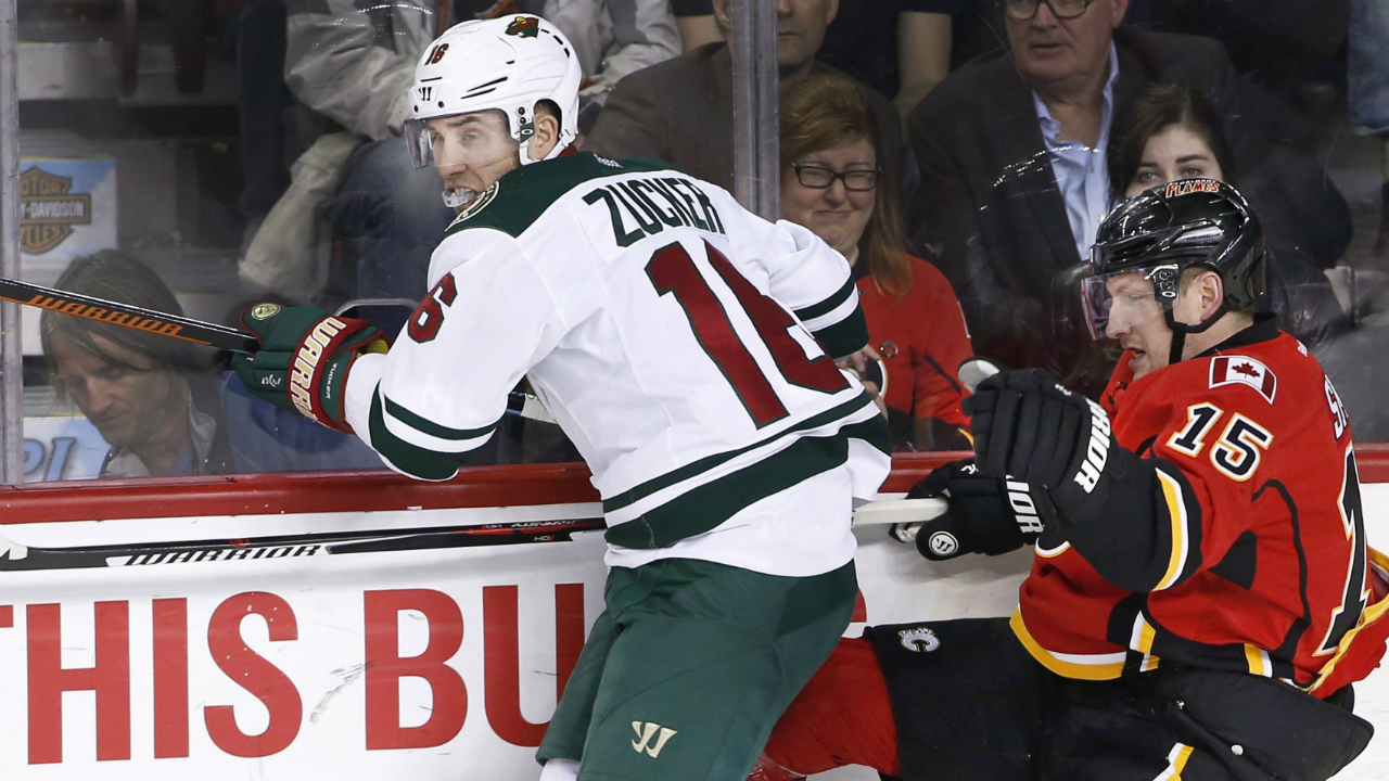 Minnesota-Wild's-Jason-Zucker-(16)-checks-Calgary-Flames'-Ladislav-Smid,-from-Czech-Republic,-during-first-period-NHL-action-in-Calgary,-Alta.,-Wednesday-Feb.-17,-2016.-THE-CANADIAN-PRESS/Larry-MacDougal