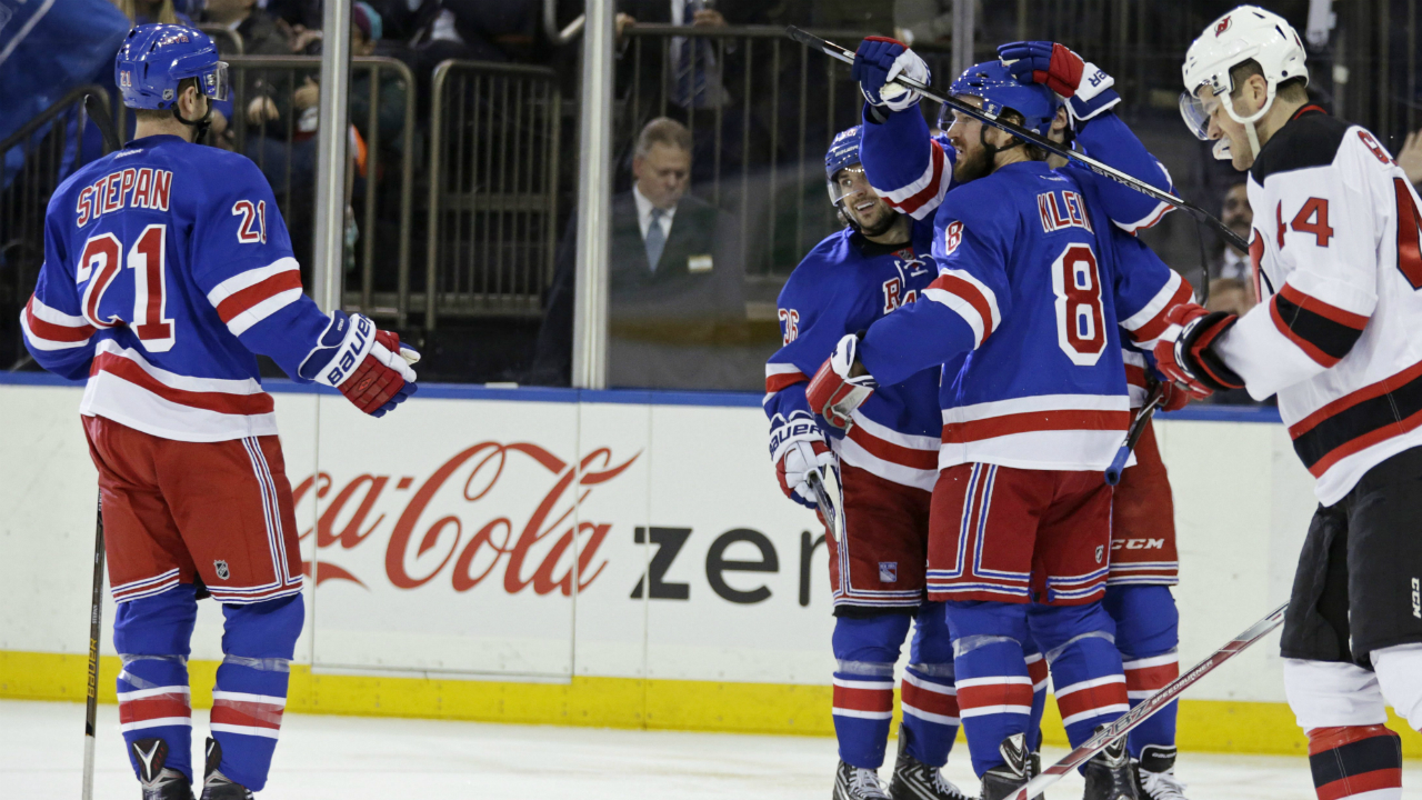 New-York-Rangers-Kevin-Klein-(8)-is-congratulated-by-teammates-after-scoring-a-goal-against-the-New-Jersey-Devils-in-the-second-period-of-an-NHL-hockey-game-Monday,-Feb.-8,-2016,-in-New-York.-(AP-Photo/Adam-Hunger)