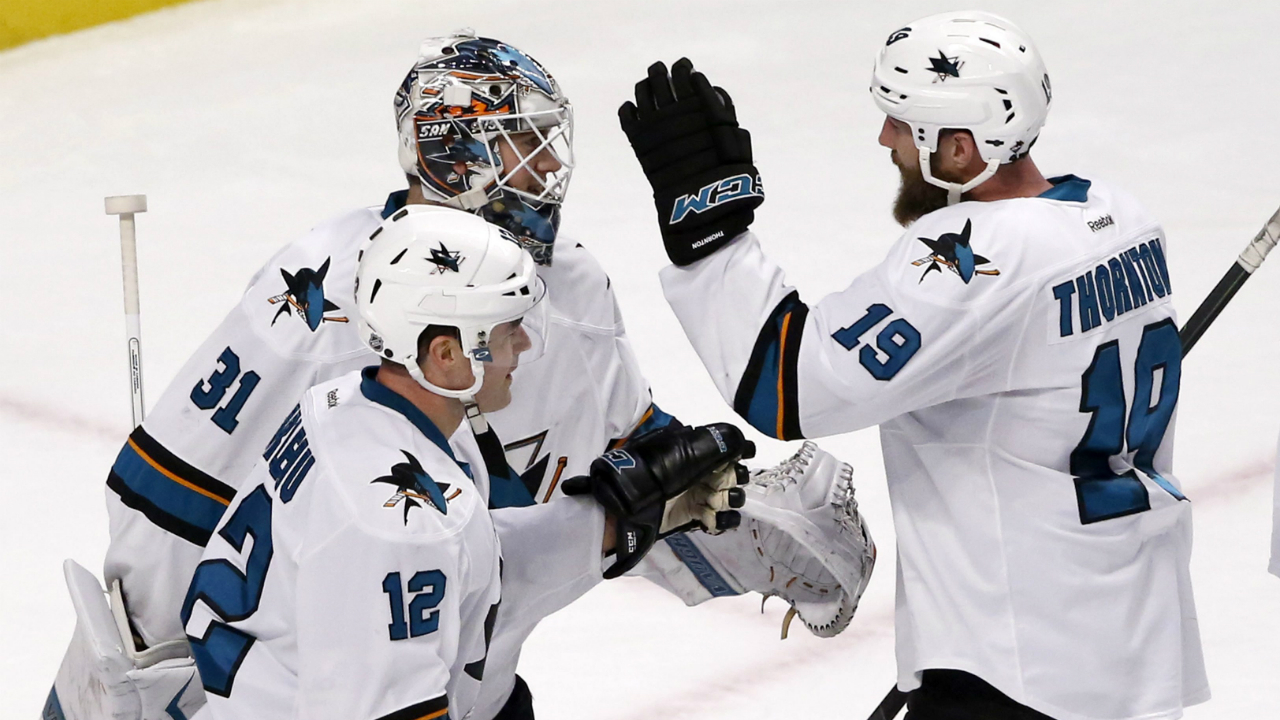 San-Jose-Sharks-goalie-Martin-Jones-(31)-celebrates-his-2-0-shutout-of-the-Chicago-Blackhawks-with-Patrick-Marleau-(12)-and-Joe-Thornton-after-an-NHL-hockey-game-Tuesday,-Feb.-9,-2016,-in-Chicago.-(AP-Photo/Charles-Rex-Arbogast)