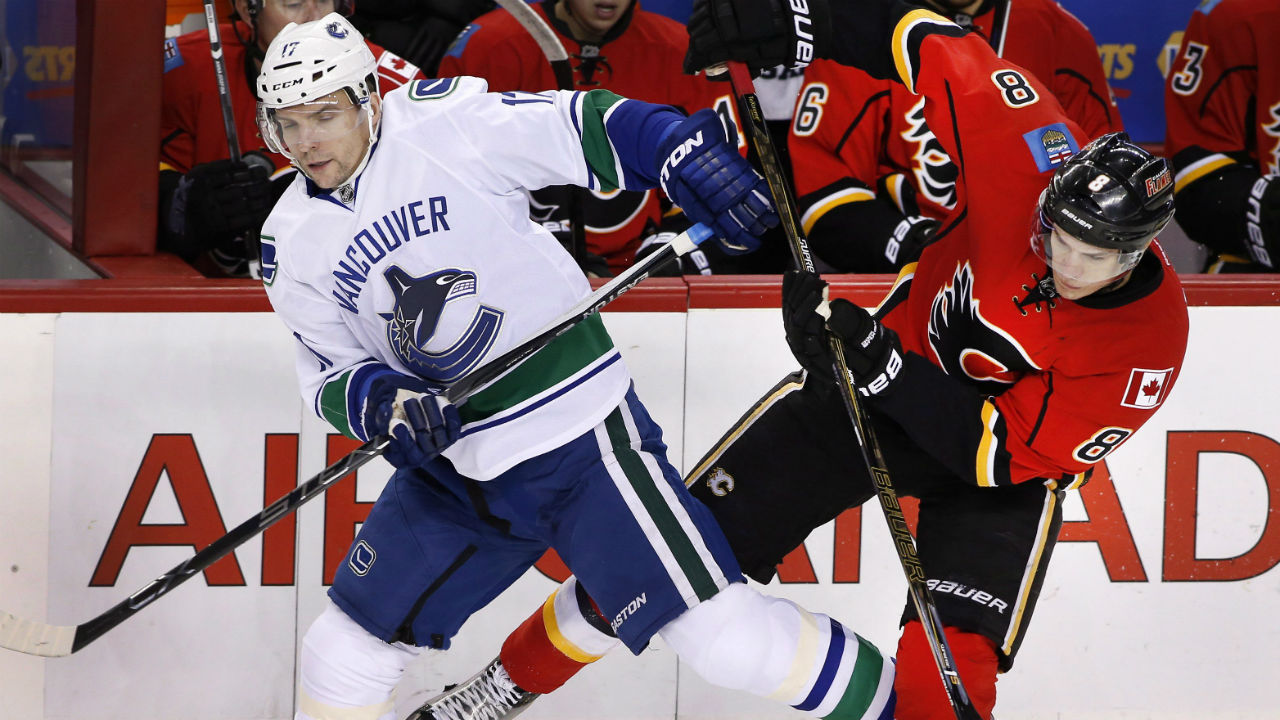 Vancouver-Canucks'-Radim-Vrbata,-left,-from-Czech-Republic,-collides-with-Calgary-Flames'-Joe-Colborne-during-first-period-NHL-action-in-Calgary,-Alta.,-Friday-Feb.-19,-2016.-THE-CANADIAN-PRESS/Larry-MacDougal