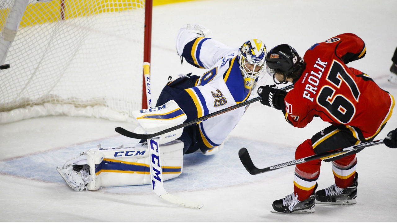 St.-Louis-Blues-goalie-Anders-Nilsson,-left,-of-Sweden,-lets-in-a-goal-from-Calgary-Flames'-Michael-Frolik,-of-the-Czech-Republic,-during-third-period-NHL-hockey-action-in-Calgary,-Monday,-March-14,-2016.-(Jeff-McIntosh/CP)