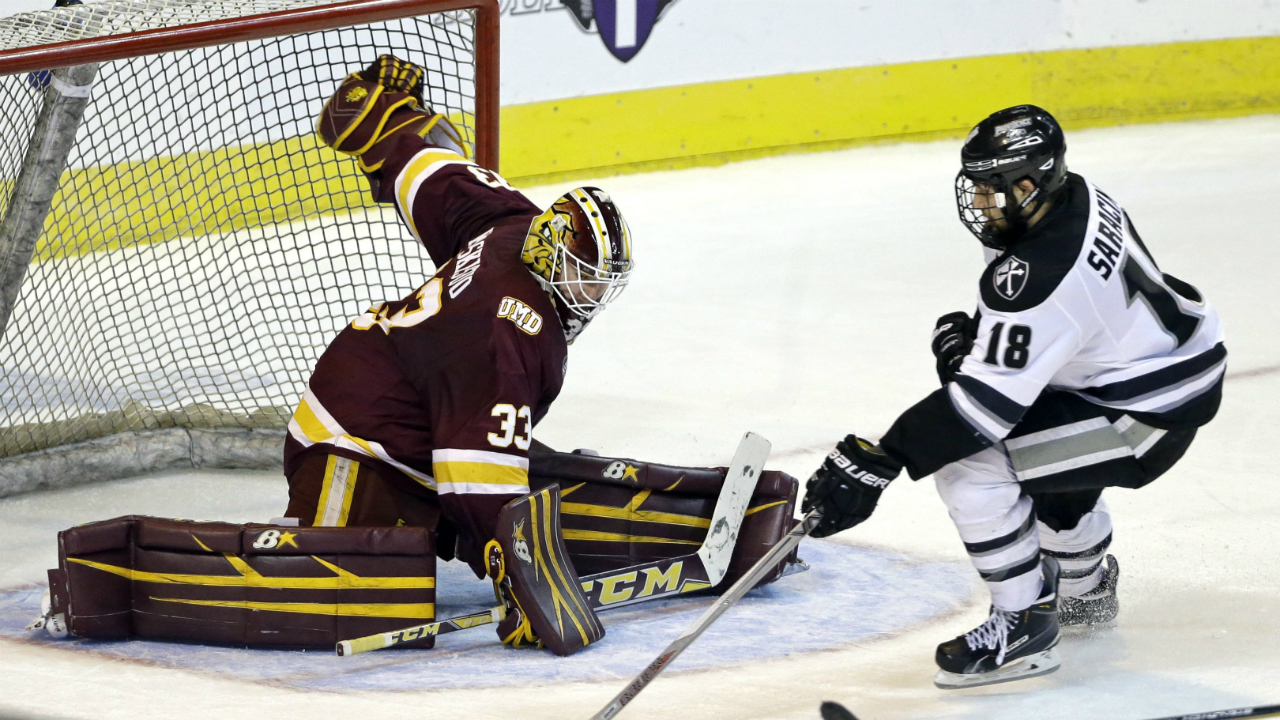 Providence-left-wing-Nick-Saracino-(18)-handles-the-puck-but-cannot-score-against-Minnesota-Duluth-goalie-Kasimir-Kaskisuo-(33)-during-the-third-period-of-a-regional-semifinal-in-the-NCAA-men's-college-hockey-tournament,-Friday,-March-25,-2016,-in-Worcester,-Mass.-Minnesota-Duluth-won-2-1-in-double-overtime.-(AP-Photo/Elise-Amendola)