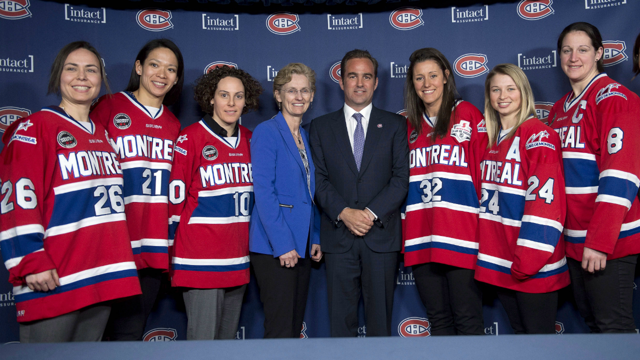 Montreal-Canadiens-chief-executive-Geoff-Molson-and-Canadian-Women's-Hockey-League-Comissioner-Brenda-Andress-pose-with-Montreal-Stars-players,-from-left,-Lisa-Marie-Breton-Lebreux,-Julie-Chu,-Noemie-Marin,-Charline-Labonte,-Ann-Sophie-Bettez,-and-Cathy-Chartrand,-right,-during-a-press-conference-in-Montreal.