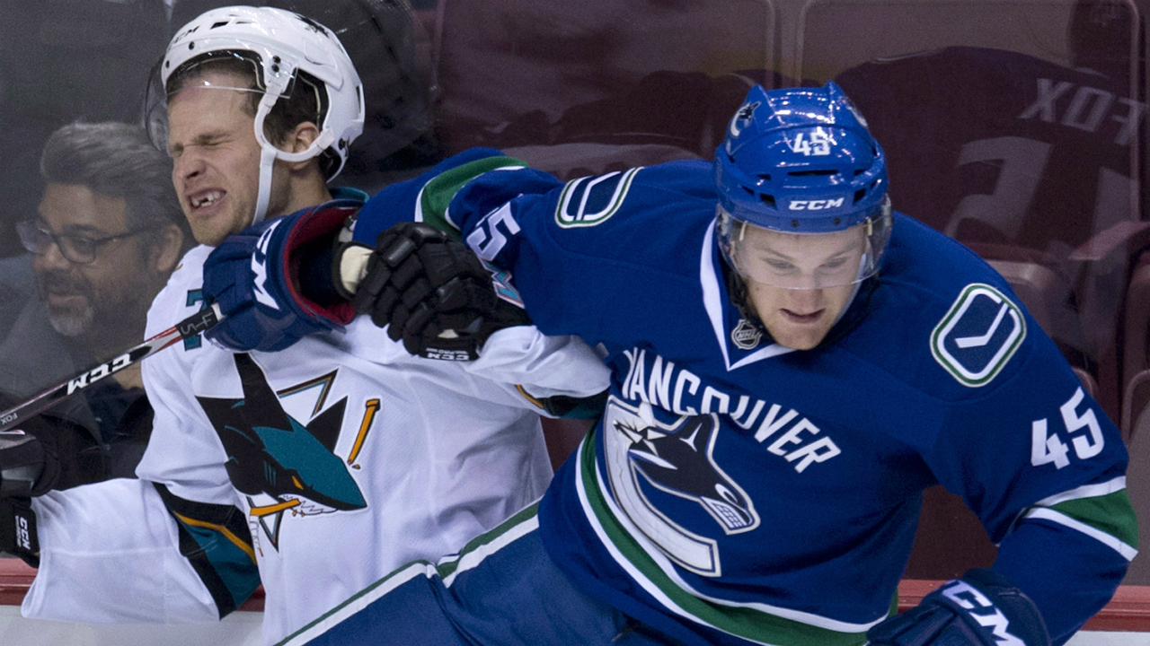Vancouver-Canucks-Dane-Fox,-right,-puts-San-Jose-Sharks-center-Rylan-Schwartz-(72)-into-the-boards-during-the-first-period-of-NHL-pre-season-action-in-Vancouver,-B.C.-Tuesday,-Sept.-23,-2014.-THE-CANADIAN-PRESS/Jonathan-Hayward