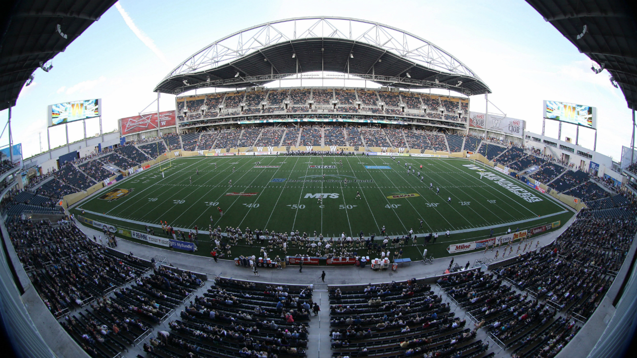The-Toronto-Argonauts'-kick-the-ball-off-to-the-Winnipeg-Blue-Bombers'-to-open-the-first-pre-season-CFL-football-game-at-Investors-Group-Field-in-Winnipeg,-Wednesday,-June-12,-2013.-The-new-stadium-hosts-the-Bombers-and-the-University-of-Manitoba-Bisons.-THE-CANADIAN-PRESS/Trevor-Hagan