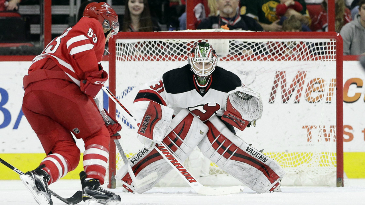 New-Jersey-Devils-goalie-Scott-Wedgewood-(31)-keeps-an-eye-on-the-puck-as-Carolina-Hurricanes'-Jeff-Skinner-(53)-looks-for-a-shot-during-the-first-period-of-an-NHL-hockey-game-in-Raleigh,-N.C.,-Sunday,-March-27,-2016.-(AP-Photo/Gerry-Broome)