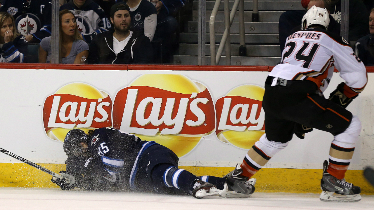 Winnipeg-Jets'-Mathieu-Perreault-(85)-hits-the-boards-after-colliding-with-Anaheim-Ducksâ€šÃ„Ã´-Simon-Despres-(24)-during-second-period-NHL-hockey-action-in-Winnipeg,-Sunday,-March-20,-2016.-After-laying-on-the-ice,-Perreault-went-to-the-locker-room.-THE-CANADIAN-PRESS/Trevor-Hagan