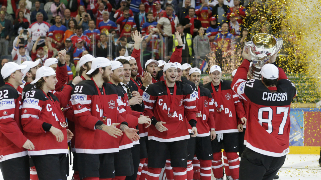 Canada’s-Sidney-Crosby,-right,-presents-his-teammates-with-a-trophy-after-winning-the-title-at-the-Hockey-World-Championships-in-Prague,-Czech-Republic,-Sunday,-May-17,-2015.-Canada-won-the-gold-medal-match-6-1-over-Russia.-(AP-Photo/Petr-David-Josek)