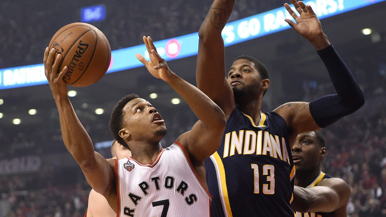 Indiana-Pacers'-Paul-George-(13)-defends-as-Toronto-Raptors'-Kyle-Lowry-(7)-drives-for-the-basket-during-first-half-NBA-playoff-basketball-action-in-Toronto-on-Tuesday,-April-26,-2016.-THE-CANADIAN-PRESS/Frank-Gunn