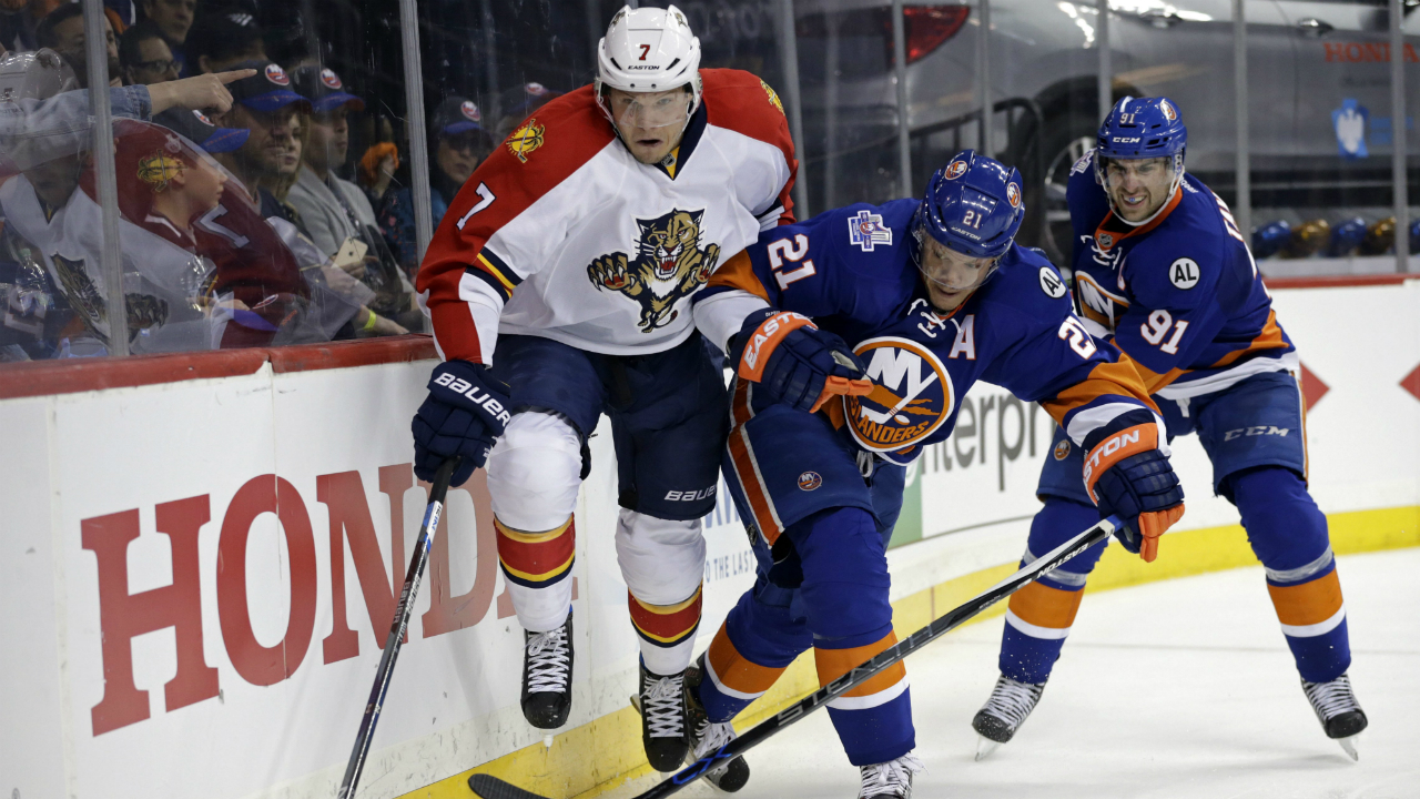 Florida-Panthers-defenseman-Dmitry-Kulikov-(7)-and-New-York-Islanders-right-wing-Kyle-Okposo-(21)-battle-for-the-puck-during-the-second-period-in-Game-3-of-an-NHL-hockey-first-round-Stanley-Cup-playoff-series,-Sunday,-April-17,-2016,-in-New-York.-(AP-Photo/Adam-Hunger)