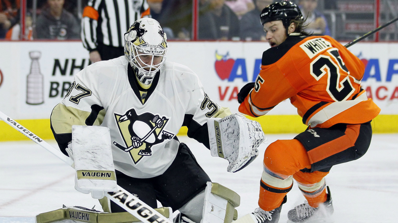 Pittsburgh-Penguins'-Jeff-Zatkoff,-front-left,-and-Philadelphia-Flyers'-Ryan-White,-right,-watch-the-puck-go-wide-of-the-net-during-the-second-period-of-an-NHL-hockey-game-Saturday,-April-9,-2016-in-Philadelphia.-The-Flyers-won-3-1.-(AP-Photo/Tom-Mihalek)