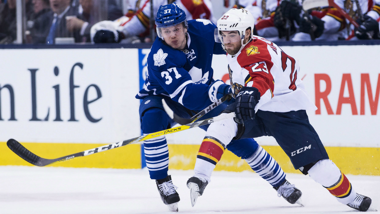 Florida-Panthers-centre-Rocco-Grimaldi-(23)-fights-off-Toronto-Maple-Leafs-right-wing-Kasperi-Kapanen-(37)-during-first-period-NHL-hockey-action-in-Toronto-on-Monday,-April-4,-2016.-THE-CANADIAN-PRESS/Nathan-Denette