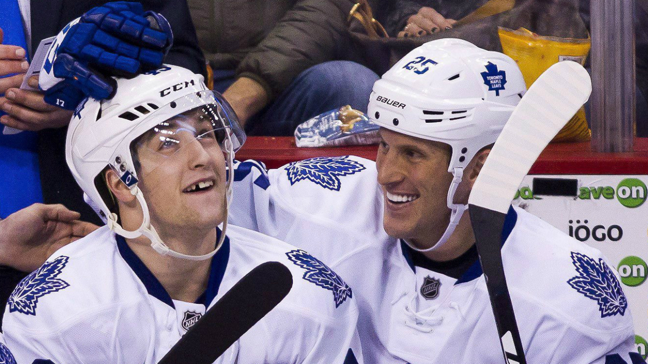 Toronto-Maple-Leafs'-Brendan-Leipsic-(49)-celebrates-his-first-career-NHL-goal-with-teammate-Rich-Clune-(25)-during-third-period-NHL-hockey-action-agianst-the-Vancouver-Canucks-in-Vancouver,-B.C.,-on-Saturday-February-13,-2016.-THE-CANADIAN-PRESS/Ben-Nelms