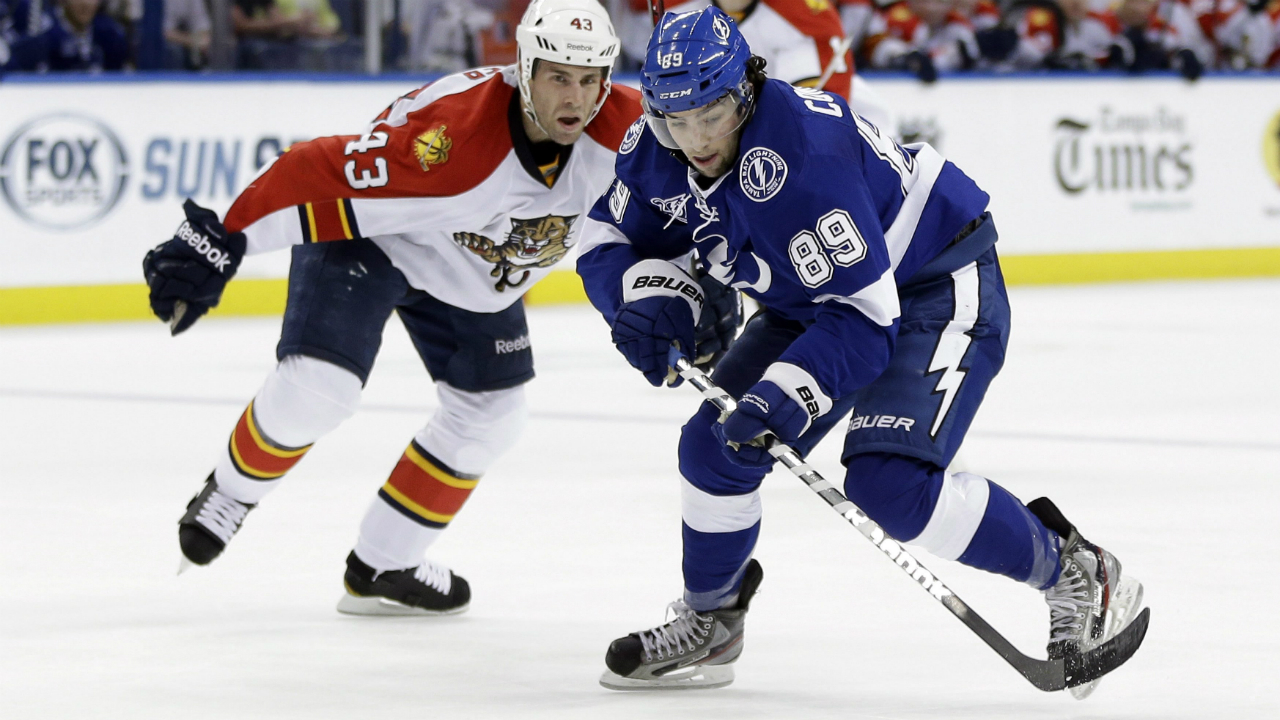 Tampa-Bay-Lightning-left-wing-Cory-Conacher-(89)-gets-past-Florida-Panthers-defenseman-Mike-Weaver-(43)-during-the-second-period-of-an-NHL-hockey-game-Tuesday,-Jan.-29,-2013,-in-Tampa,-Fla.-Conacher-was-called-for-holding-on-the-play.-(AP-Photo/Chris-O'Meara)