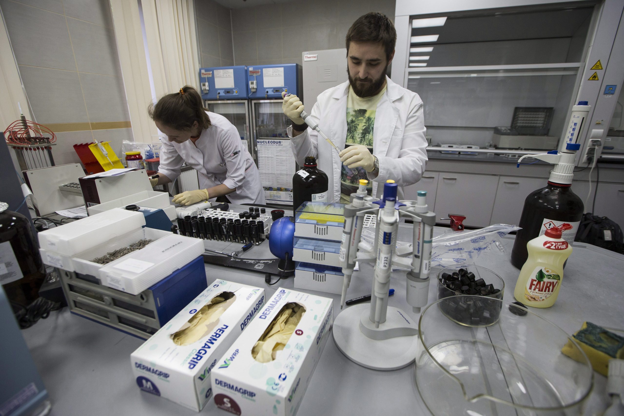 Employees Natalya Bochkaryova, left, and Ilya Podolsky work at the Russia's national drug-testing laboratory in Moscow, Russia, Tuesday, May 24, 2016. The Russians have been accused of state-sponsored doping at the 2014 Sochi Olympics, and the IOC has asked WADA to carry out a full-fledged investigation and plans to retest Sochi samples. Russian Anti Doping Agency RUSADA organised a press tour of its anti doping laboratory on Tuesday. (AP Photo/Alexander Zemlianichenko)