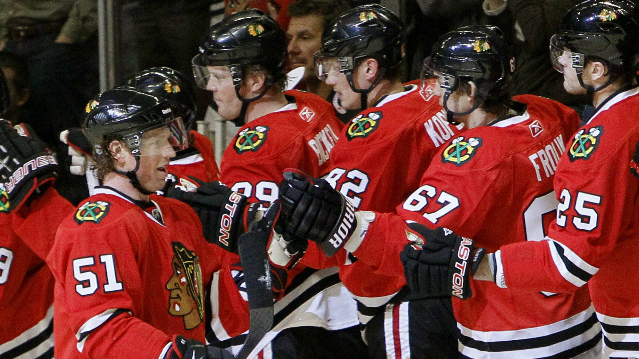In-this-2011-file-photo,-defenceman-Brian-Campbell-celebrates-a-goal-with-his-Chicago-Blackhawks-teammmates.-(AP-Photo/Charles-Rex-Arbogast)