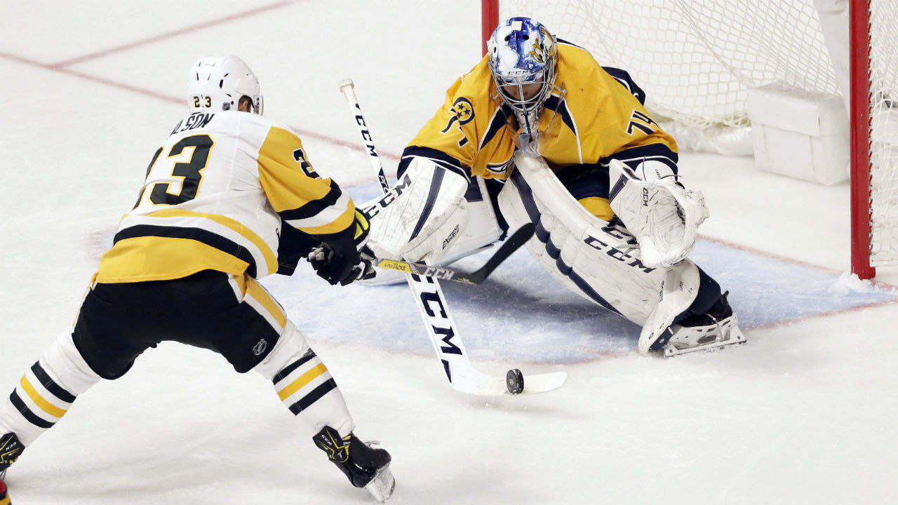 Juuse Saros blocks a shot by then-Penguin Scott Wilson. (Mark Humphrey/AP)