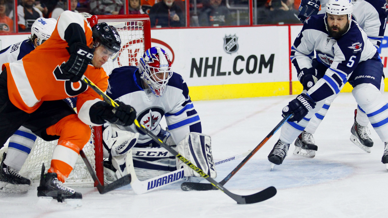 Philadelphia-Flyers'-Petr-Straka-(51)-left,-digs-for-the-loose-puck-as-Winnipeg-Jets-goalie-Michael-Hutchinson-(34),-center,-and-Mark-Stuart-(5),-right,-defend-in-the-second-period-of-an-NHL-hockey-game,-Thursday,-Jan.-29,-2015,-in-Philadelphia.-(AP-Photo/Tom-Mihalek)