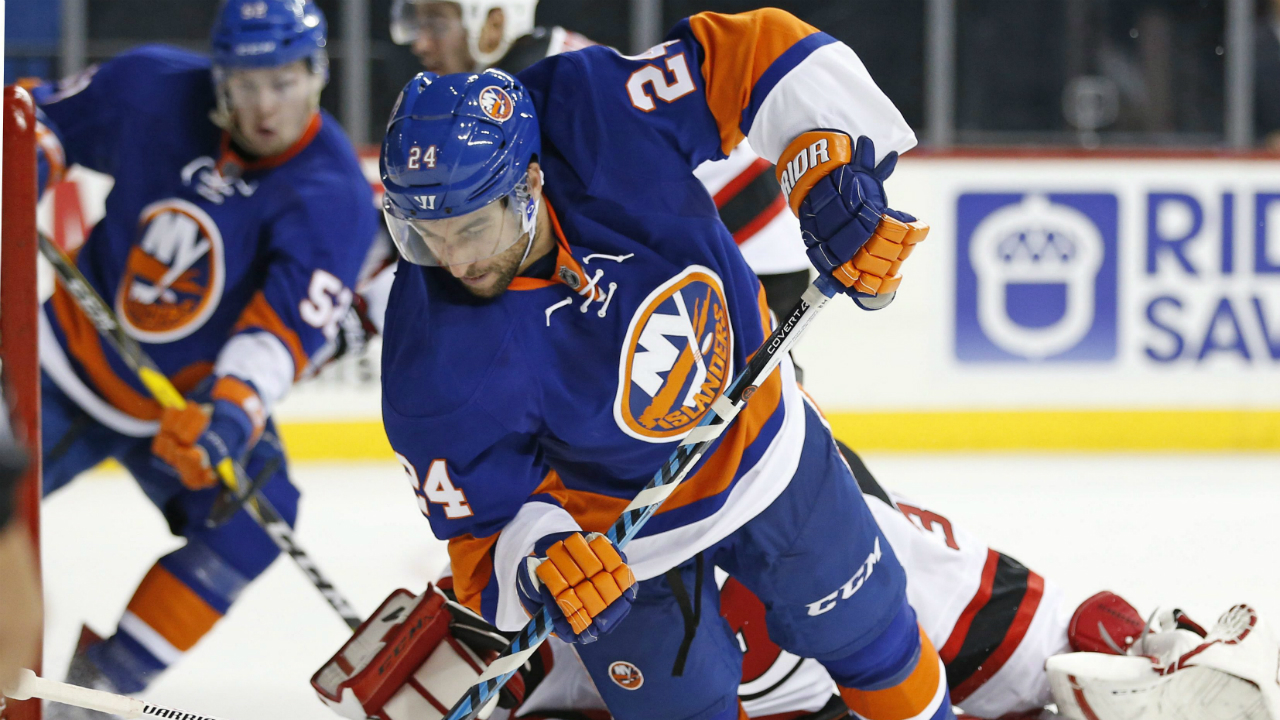 New-York-Islanders-centre-Stephen-Gionta-(24)-trips-on-New-Jersey-Devils-goalie-Cory-Schneider-trying-for-a-shot-on-goal-during-the-second-period-of-a-preseason-hockey-game,-Monday,-Oct.-3,-2016,-in-New-York.-Islanders-left-wing-Ross-Johnston-(52)-watches-from-left-of-the-crease.-(Kathy-Willens/AP)