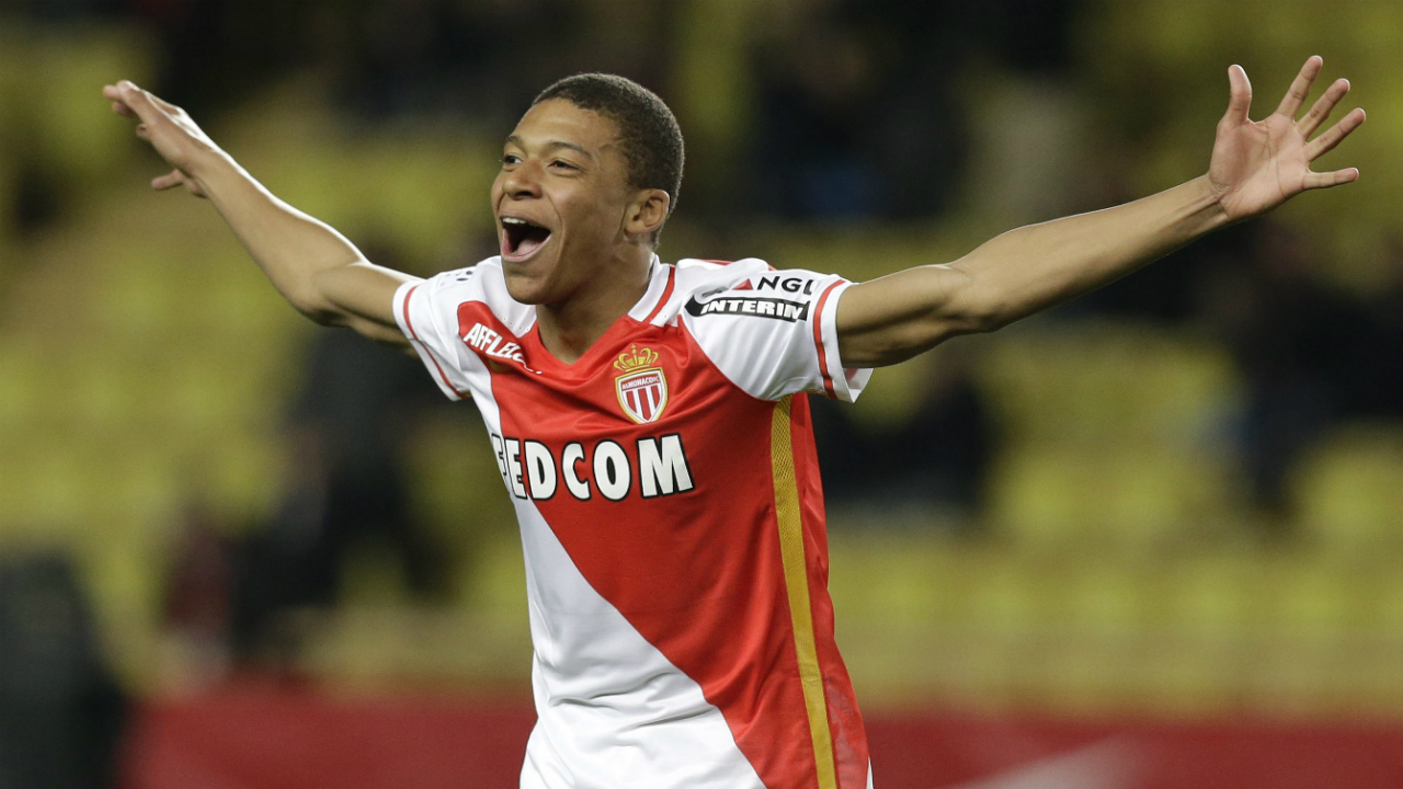 In-this-Saturday,-Feb.-20,-2016-file-photo,-Monaco's-Kylian-Mbappe-Lottin-celebrates-scoring-the-third-goal-against-Troyes-during-their-French-League-One-soccer-match,-in-Monaco.-Because-of-his-electric-speed-and-style-of-play,-the-18-year-old-Mbappe-has-drawn-comparisons-with-Thierry-Henry,-who-is-also-France's-record-scorer.-(Lionel-Cironneau/AP)