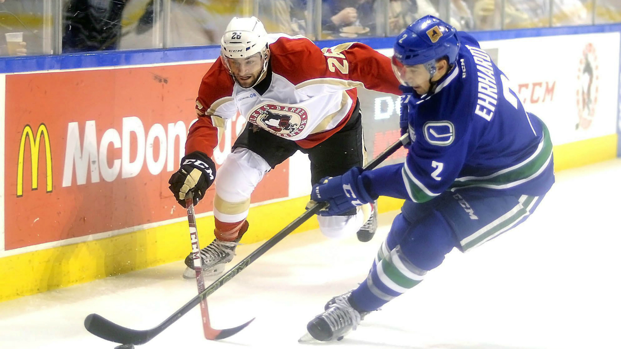 Utica-Comets-defenceman-Travis-Ehrhardt-(2)-skates-with-the-puck-ahead-of-the-Wilkes-Barre-Scranton-Penguins-left-wing-Dominik-Uher-(26)-during-the-first-period-of-an-AHL-hockey-game,-Saturday,-Jan.-9,-2016-at-the-Mohegan-Sun-Arena-in-Wilkes-Barre,-Pa.-(Mark-Moran/The-Citizens'-Voice-via-AP)