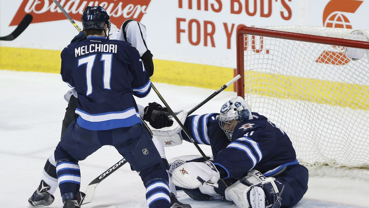 Winnipeg-Jets-goaltender-Ondrej-Pavelec-(31)-saves-the-shot-from-Los-Angeles-Kings'-Andy-Andreoff-(15)-as-Jets'-Julian-Melchiori-(71)-defends-during-first-period-NHL-action-in-Winnipeg-on-Thursday,-March-24,-2016.-(John-Woods/CP)