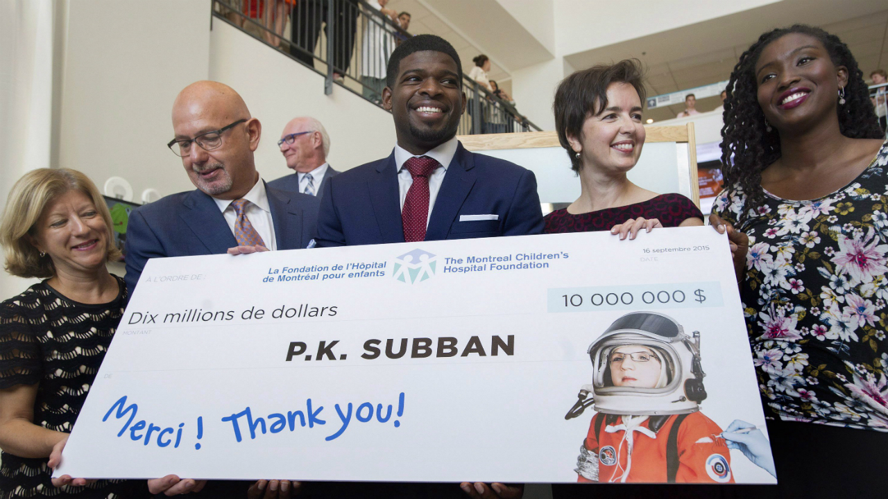Montreal-Canadiens-defenceman-P.K.-Subban,-centre,-smiles-as-he-poses-for-the-cameras-following-a-press-conference-at-the-Children's-Hospital-in-Montreal,-Wednesday,-September-16,-2015,-where-he-announced-that-his-foundation-would-pledge-$10-million-to-the-hospital.-(Graham-Hughes/CP)