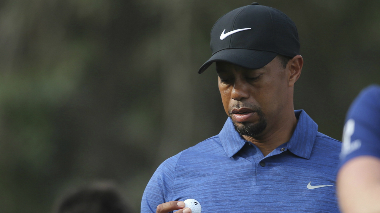 In-this-Thursday,-Feb.-2,-2017-photo,-Tiger-Woods-reacts-on-hole-11th-during-the-1st-round-of-the-Dubai-Desert-Classic-golf-tournament-in-Dubai,-United-Arab-Emirates.-Tiger-Woods-has-withdrawn-from-the-Dubai-Desert-Classic-with-an-apparent-back-injury-after-shooting-an-opening-round-5-over-77.-(Kamran-Jebreili/AP)