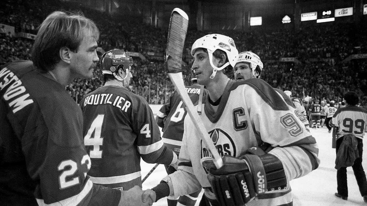 Bob-Nystrom-of-the-New-York-Islanders-congratulates-Wayne-Gretzky-and-the-Edmonton-Oilers-on-their-Stanley-Cup-victory,-Edmonton,-Alta.,-May-19,-1984.-The-Oilers-won-the-game-5-2.-(The-Canadian-Press)