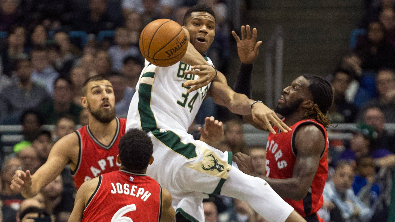 Milwaukee-Bucks'-Giannis-Antetokounmpo-passes-the-ball-out-after-being-stopped-by-Toronto-Raptors'-Jonas-Valanciunas,-left,-DeMarre-Carroll,-right,-and-Cory-Joseph,-center,-during-the-first-half-of-an-NBA-basketball-game-Saturday,-March-4,-2017,-in-Milwaukee.-(Tom-Lynn/AP)